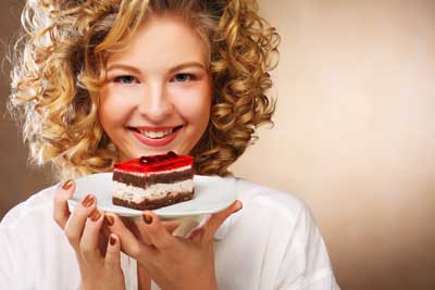 Beautiful young woman enjoying a dessert